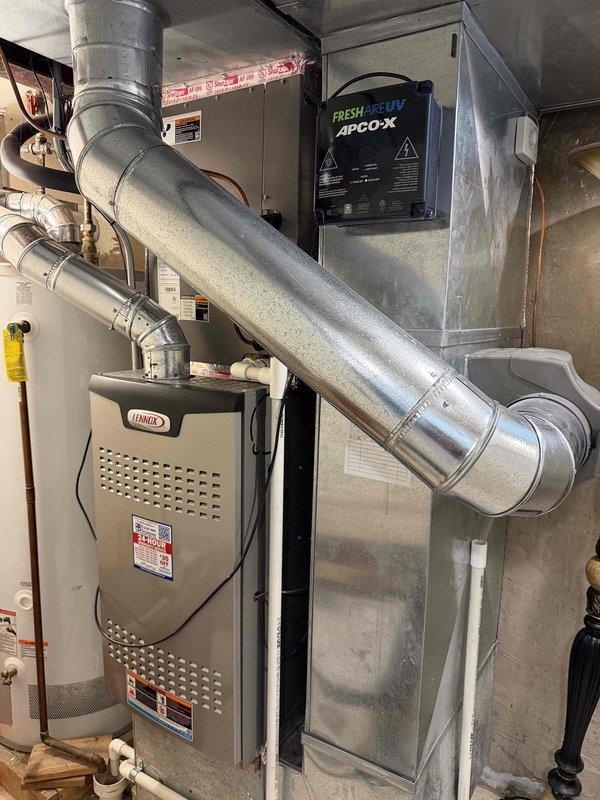 Completed comprehensive HVAC maintenance agreement service, performing clean and check on two condenser units. Verified system operation, measured supply air temperature at 45°F indicating proper cooling performance, and inspected Lennox furnace installation with APCO-X fresh air UV purification system. All equipment found operating within normal parameters with ductwork properly sealed and connections secure.