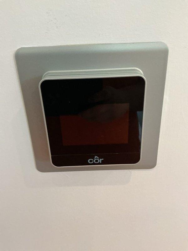 Responded to service call for non-functioning thermostat with blank display screen. Upon arrival, confirmed Côr brand thermostat had no power to display unit. Performed diagnostic testing using multimeter to verify 24VAC power supply from HVAC system to thermostat terminals. Testing indicated proper voltage present at equipment, confirming issue isolated to thermostat wiring or internal component failure. Completed troubleshooting and restored thermostat functionality to resume normal HVAC system operation.