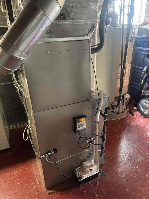 Completed installation of new air conditioning unit and evaporator coil in residential basement location. Utilized existing refrigerant line set, performed vacuum test to verify system integrity and confirm no leaks present. Two-technician crew completed work in approximately six hours. System operational and tested at completion, with temperature readings confirming proper functionality.