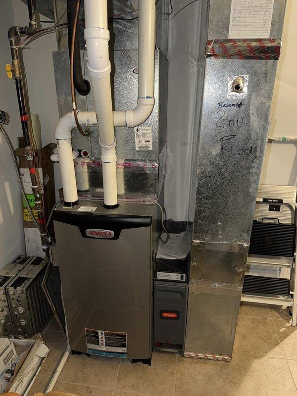 Completed comprehensive cooling maintenance agreement service on three air conditioning systems with gas furnace included. Performed thorough inspection of Lennox furnace installation in basement utility area, checking all PVC venting connections, drainage lines, and electrical components. Accessed and inspected capacitor compartments on multiple AC units, verifying proper operation of run capacitors (including 10mfd blower capacitor), contactors, and all electrical connections. All wiring terminals were found secure with appropriate color-coded connections intact. Documented equipment conditions through photographic records for maintenance history. All systems operational and performing within manufacturer specifications upon completion of preventive maintenance inspection.