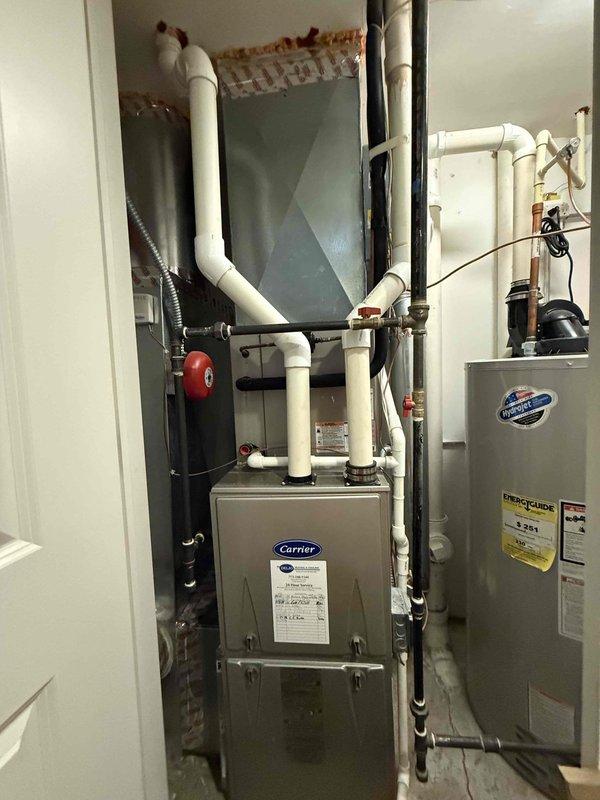 Completed routine maintenance inspection on Carrier furnace system as part of cooling season agreement. Performed visual inspection of blower assembly, verifying proper blade condition and clearances on squirrel cage fan component. Documented equipment condition including furnace unit, associated PVC condensate drainage system, and connected HVAC components in utility space. All systems operational with no immediate service requirements identified.