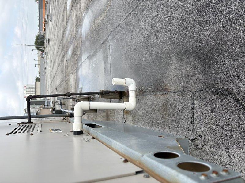 Conducted site assessment for commercial rooftop unit replacement, evaluating existing 6-ton RTU and documenting current rooftop conditions including membrane type, drainage systems, and equipment access. Photographed unit nameplate specifications and surrounding rooftop infrastructure to provide accurate quote for replacement equipment and installation requirements.