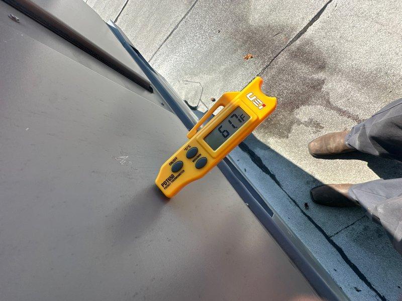 Responded to front lobby A/C not operating. Upon arrival, accessed rooftop unit and performed temperature diagnostics using digital measurement equipment. Recorded ambient temperature reading of 84.2°F and supply air temperature of 67.9°F, indicating system was functioning and producing cooled air with approximately 16°F temperature differential. Verified unit operation, confirmed airflow, and determined A/C system was operational at time of inspection.