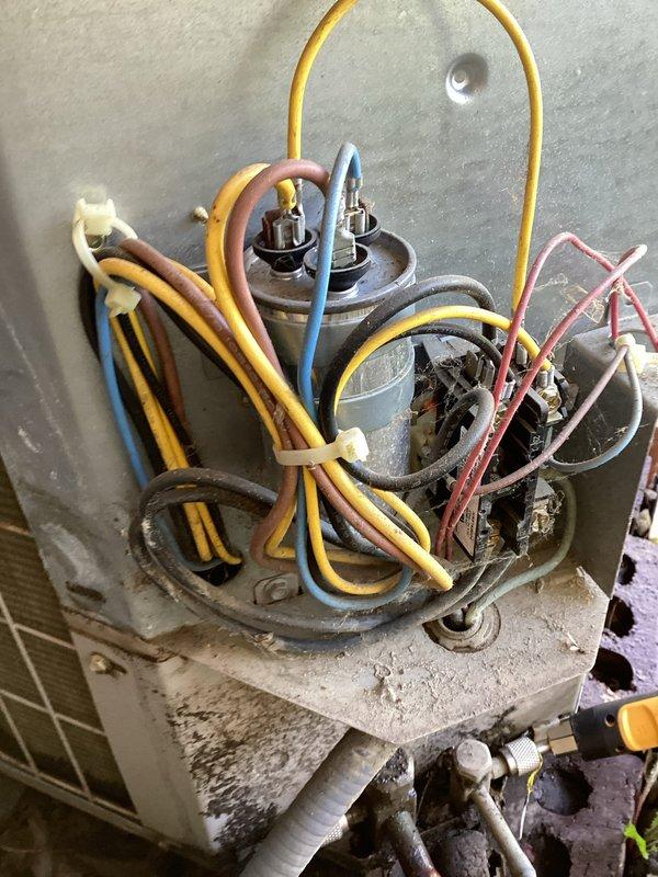 Completed comprehensive AC tune-up on 23-year-old outdoor condensing unit addressing high humidity concerns in apartment. Performed full system inspection, cleaned condenser coils, checked electrical connections and capacitor functionality, verified refrigerant levels, and tested system operation. Unit showed signs of age with visible corrosion on fan grille and accumulated debris, but all components were serviced and system restored to proper working condition.