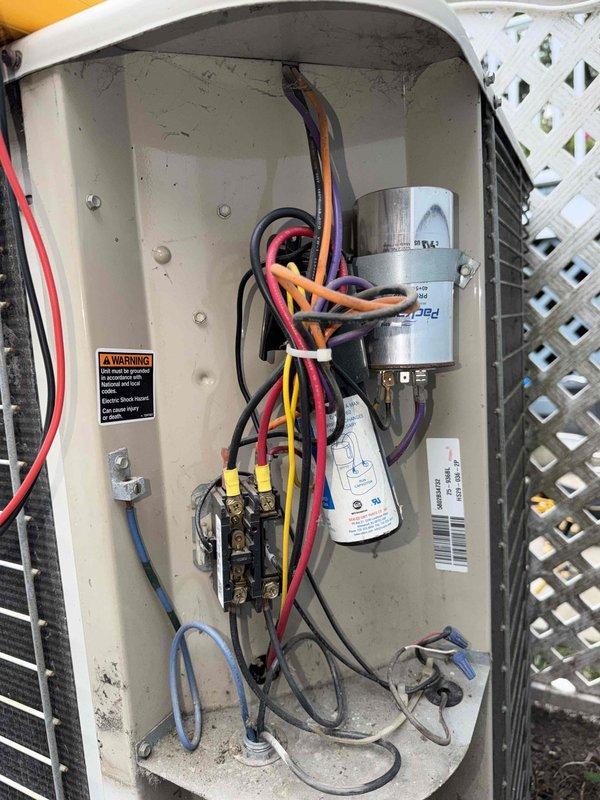 Responded to service call for AC unit not cooling and making noise upon startup. Inspected outdoor condensing unit and found electrical connections at contactor showing signs of wear and outdoor exposure. Examined capacitor, contactor assembly, and associated wiring within electrical compartment. All wire connections were secured and terminals cleaned. Verified proper voltage and amperage at contactor. Capacitor tested within acceptable range. Unit cycled successfully with normal operation restored and noise eliminated upon startup.