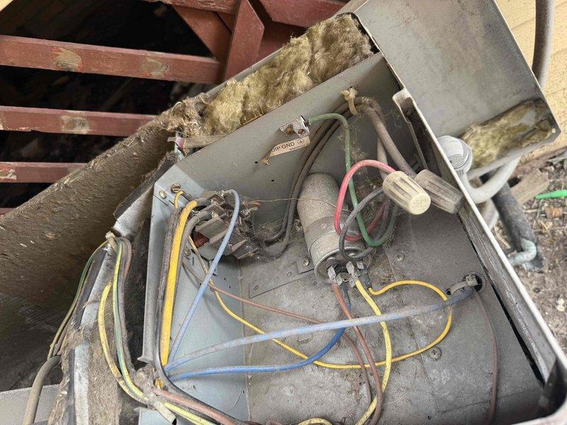 # HVAC Service Completed

Responded to no cooling complaint for dual AC system inspection. Upon arrival, accessed equipment through rear entrance and conducted diagnostic evaluation of both air conditioning units.

Inspection revealed significant refrigeration system issues on primary unit. Found heavy frost and ice accumulation on suction line, indicating restricted airflow or low refrigerant charge. Compressor showed excessive condensation on exterior surface, confirming unit was operating under abnormal conditions. Observed disorganized wiring in control compartment with multiple connections requiring attention for safety and proper operation.

Documented equipment condition with photographic evidence showing frosted suction line, wet compressor surfaces, and general accumulation of dirt and debris on base pan and components. Heat exchanger coils and condenser fins visible but require further evaluation for airflow restriction.

System requires follow-up service to address refrigera