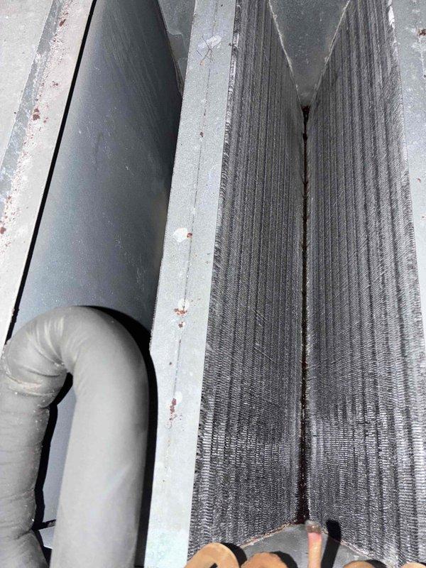 Responded to no airflow complaint on 10+ year old air conditioning system. Upon arrival, confirmed outdoor compressor was running but indoor unit was not delivering conditioned air to living space. Measured supply air temperature at register showing 65.4°F, indicating inadequate cooling performance. Inspected attic installation and identified failed or disconnected supply duct at plenum connection. Flexible ductwork was found completely detached from main trunk line, causing all conditioned air to dump into attic space rather than reaching occupied areas. Reconnected supply duct to plenum and secured connection properly. Verified airflow restoration at registers and system operation returned to normal. Customer declined further repairs at this time.