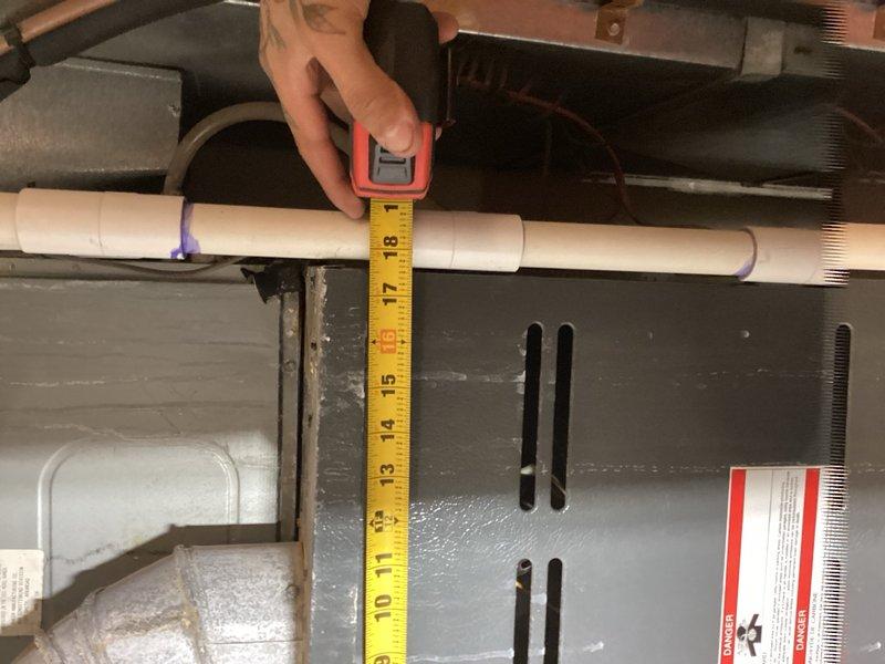 Responded to callback for intermittent indoor fan operation. Performed diagnostic evaluation of blower motor and control board assembly, taking measurements and documentation of clearances and component positioning within the air handler. Verified system operation and documented findings with photographic evidence of the mechanical components and piping configuration for service records.