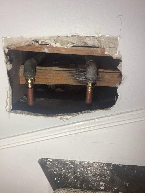 Replaced leaking galvanized pipe riser with new copper piping. Removed section of interior drywall to access vertical plumbing lines, cut out deteriorated galvanized pipe, and installed copper pipe with brass fittings to restore proper water flow and eliminate leaks.