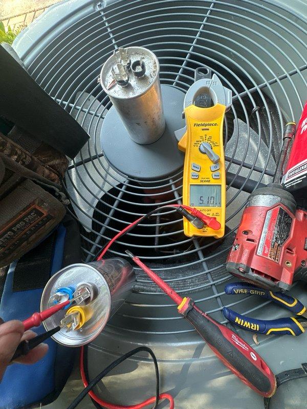 Responded to no cooling complaint on residential air conditioning system. Upon arrival, performed diagnostic testing on outdoor condenser unit and identified failed run capacitor. Verified capacitor failure using digital multimeter, confirming inadequate microfarad reading and preventing compressor from operating properly. Replaced defective dual run capacitor with new Totaline P291-4554RS capacitor meeting manufacturer specifications. Tested system operation, confirmed proper amperage draw on compressor, and verified unit returned to normal cooling operation.