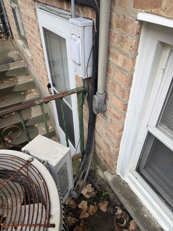 Provided comprehensive estimate for complete HVAC system replacement including both air conditioning and furnace units, both approximately 30+ years old and at end of service life. Assessed existing basement mechanical room installation with aging brown furnace and outdoor condenser unit positioned in side passage between buildings. Documented current system configuration including ductwork, electrical connections, and condensate drainage for replacement specifications.