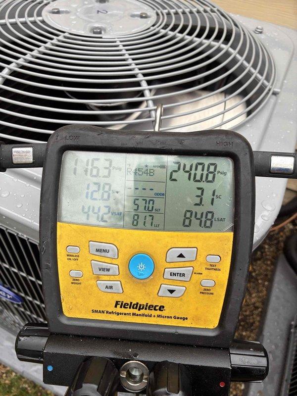 Responded to callback for AC unit installed previous day reporting no cooling. Upon arrival, performed diagnostic testing of outdoor condensing unit using refrigerant manifold gauges. Measured system pressures and temperatures to verify proper refrigerant charge and system operation. High-side pressure reading of approximately 240-250 PSIG and low-side pressure of 116-117 PSIG indicated system was operating within normal parameters. Confirmed compressor engagement and proper fan operation on condensing unit. System found to be cooling properly with no mechanical or refrigerant issues identified.