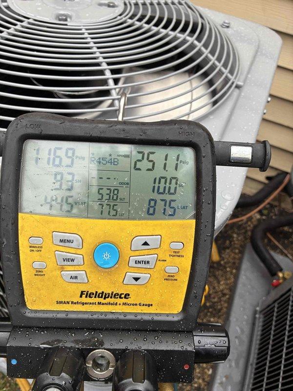 Responded to callback for AC unit installed previous day reporting no cooling. Upon arrival, performed diagnostic testing of outdoor condensing unit using refrigerant manifold gauges. Measured system pressures and temperatures to verify proper refrigerant charge and system operation. High-side pressure reading of approximately 240-250 PSIG and low-side pressure of 116-117 PSIG indicated system was operating within normal parameters. Confirmed compressor engagement and proper fan operation on condensing unit. System found to be cooling properly with no mechanical or refrigerant issues identified.