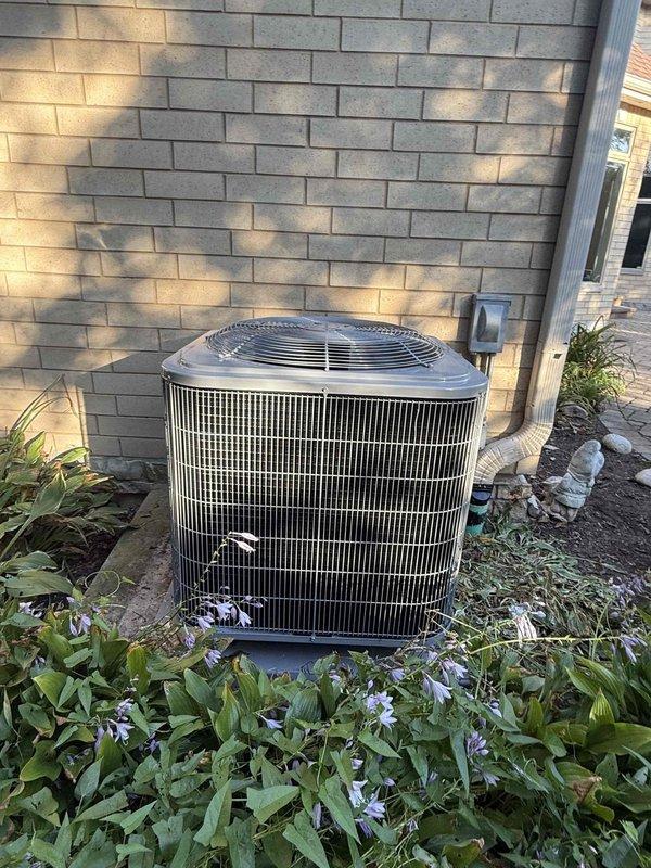 # HVAC Install - A/C Only

Completed full air conditioning system replacement including outdoor condenser unit and indoor evaporator coil. Removed existing equipment and installed new condenser on exterior pad against brick foundation wall with proper clearances maintained from structure and landscaping. Unit positioned to optimize airflow and service access while minimizing visual impact on property aesthetics.

Installed new evaporator coil in basement mechanical space, properly suspended and secured to structural supports. Established refrigerant line connections between indoor and outdoor components using appropriate copper piping with proper insulation. Connected condensate drainage system utilizing PVC piping with multiple drain points and proper pitch to prevent water backup. Verified all electrical connections meet code requirements and manufacturer specifications.

System was evacuated, leak tested, and charged with refrigerant to manufacturer specifications. Performed operati