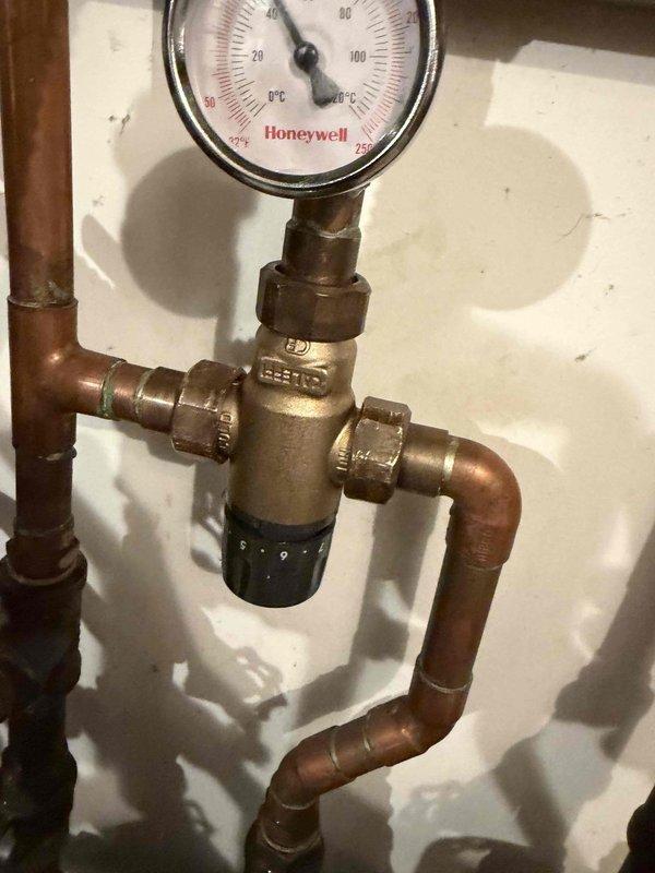 Completed return visit to replace failed circulating pump on hydronic heating system. Drained system, installed new circulating pump, and replaced malfunctioning thermostatic mixing valve with new Honeywell pressure-monitored valve assembly. Refilled system, purged air from lines, verified proper pressure readings on gauge, and tested all connections for leaks to ensure optimal system operation.