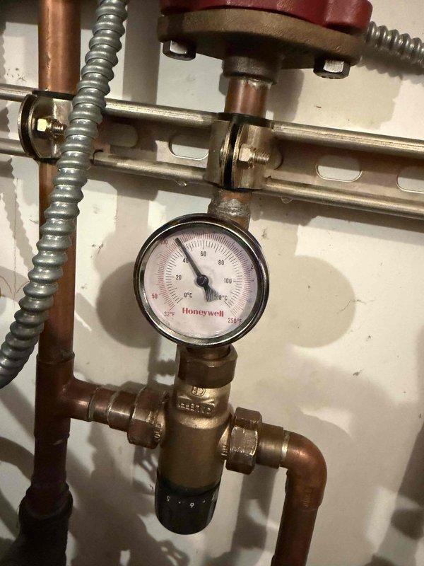 Completed return visit to replace failed circulating pump on hydronic heating system. Drained system, installed new circulating pump, and replaced malfunctioning thermostatic mixing valve with new Honeywell pressure-monitored valve assembly. Refilled system, purged air from lines, verified proper pressure readings on gauge, and tested all connections for leaks to ensure optimal system operation.