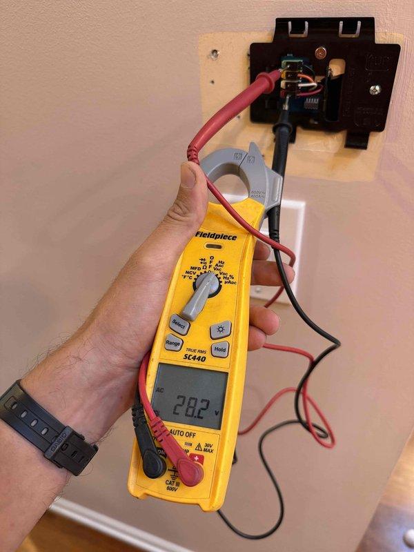 Responded to a no cooling call on a 9-year-old Carrier system with an Infinity thermostat displaying a blank screen. Upon arrival, tested voltage at the thermostat base using a clamp meter, which showed 202 volts, indicating a power supply issue. Accessed the air handler control board and identified failed thermostat transformer causing loss of 24-volt control power to the thermostat. Replaced the defective transformer, verified proper voltage output at 24VAC, reconnected all low-voltage wiring to the control board terminals, and restored power to the Infinity thermostat. System powered up successfully, thermostat display functional, and cooling operation confirmed working properly.