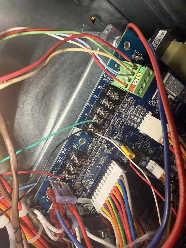 Responded to a no cooling call on a 9-year-old Carrier system with an Infinity thermostat displaying a blank screen. Upon arrival, tested voltage at the thermostat base using a clamp meter, which showed 202 volts, indicating a power supply issue. Accessed the air handler control board and identified failed thermostat transformer causing loss of 24-volt control power to the thermostat. Replaced the defective transformer, verified proper voltage output at 24VAC, reconnected all low-voltage wiring to the control board terminals, and restored power to the Infinity thermostat. System powered up successfully, thermostat display functional, and cooling operation confirmed working properly.