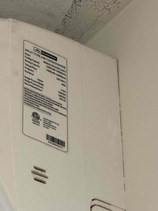 Conducted estimate for mini split system replacement consisting of 5 indoor heads approximately 4-5 years old. Documented existing equipment condition showing significant water damage to ceiling near one indoor unit with visible staining, discoloration, and material deterioration indicating moisture infiltration. Photographed split-type air conditioner specifications and multiple wall-mounted ductless units throughout property. Assessed system viability and provided repair versus replacement options for aging multi-zone mini split installation.