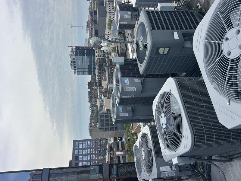 Responded to warranty call for reported rattling sound in ductwork. Conducted thorough inspection of rooftop HVAC system including multiple condensing units and associated ductwork. Verified all mechanical connections, inspected electrical panel and circuit breakers for proper operation, and examined duct supports and fasteners. No abnormal vibrations or loose components detected during system operation at time of inspection.