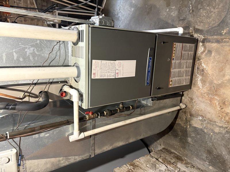 Completed full HVAC system replacement for first floor air conditioning unit. Installed new furnace with proper venting configuration including PVC intake and exhaust pipes, connected refrigerant lines, and verified electrical connections in basement utility space. All equipment mounted on appropriate platform with manufacturer specifications confirmed and system operational upon completion.