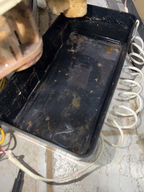 Responded to no cooling complaint on 5-year-old air conditioning system. Upon arrival, found standing water in drain pan preventing unit operation due to safety float switch activation. Inspected evaporator coil assembly and identified severely clogged condensate drain line and heavily soiled drain pan with significant debris accumulation. Cleared condensate drain line obstruction to restore proper drainage. Cleaned and sanitized drain pan, removing accumulated dirt, dust, and biological growth. Replaced dirty air filter with clean filter to improve airflow and system efficiency. Verified proper condensate drainage and confirmed safety float switch reset. Tested system operation and verified unit cooling properly with no further drainage issues. System restored to normal operation.