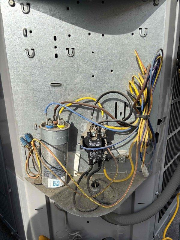 Completed routine maintenance agreement service on Puron R-410A cooling system, model CNPHP2417ALAAAAA. Accessed crawlspace filter location using 12-foot ladder to replace 16x25x1 filter. Inspected electrical components including capacitor, contactor, and associated wiring connections, confirming all components operating within normal parameters. Documented unit specifications and current operating condition with photographs for service records.