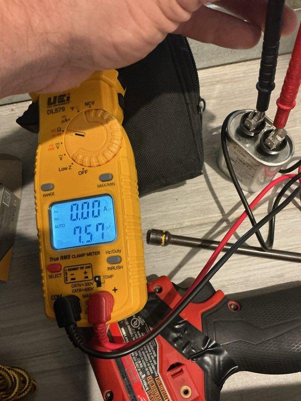 Responded to customer report of loud humming noise following recent fan blade and motor installation. Performed diagnostic testing of electrical components using clamp meter, measuring capacitor performance and verifying proper voltage readings. System tested and found operating within normal parameters, with thermostat maintaining proper communication and temperature control at 68 degrees in cooling mode.