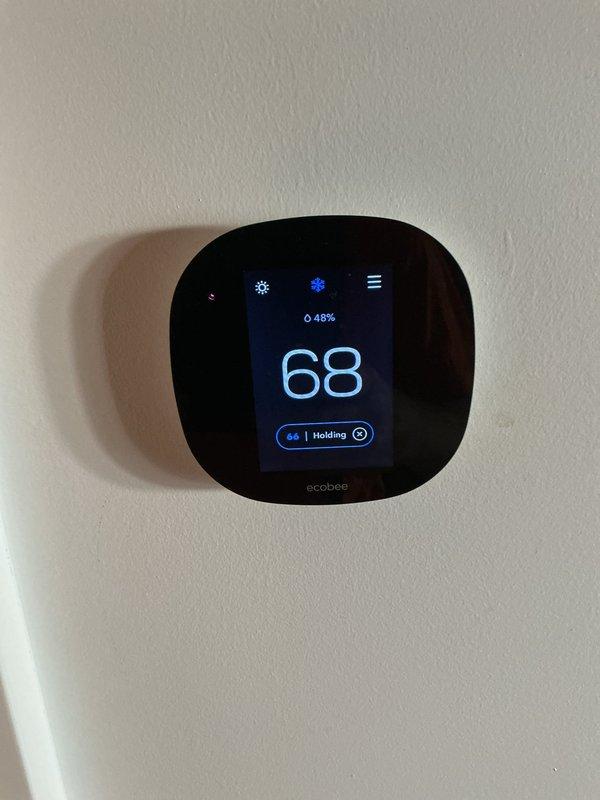 Responded to customer report of loud humming noise following recent fan blade and motor installation. Performed diagnostic testing of electrical components using clamp meter, measuring capacitor performance and verifying proper voltage readings. System tested and found operating within normal parameters, with thermostat maintaining proper communication and temperature control at 68 degrees in cooling mode.