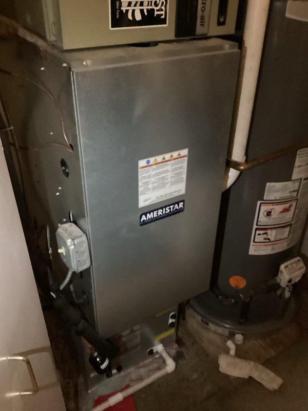 Responded to no-cool call with reported water leak from upstairs AC unit dripping into bedroom below. Upon arrival, inspected 10+ year old Ameristar air handler system and associated condensate drain system. Utilized inspection camera to examine evaporator coil and drain pan condition internally. Found condensate drain line issue causing water overflow from drain pan. Cleared blockage in PVC condensate drain line, verified proper drainage flow, and tested system operation to confirm leak was resolved and unit cooling properly.