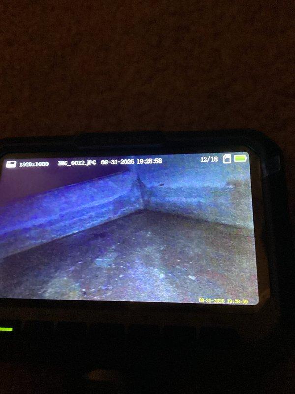 Responded to no-cool call with reported water leak from upstairs AC unit dripping into bedroom below. Upon arrival, inspected 10+ year old Ameristar air handler system and associated condensate drain system. Utilized inspection camera to examine evaporator coil and drain pan condition internally. Found condensate drain line issue causing water overflow from drain pan. Cleared blockage in PVC condensate drain line, verified proper drainage flow, and tested system operation to confirm leak was resolved and unit cooling properly.