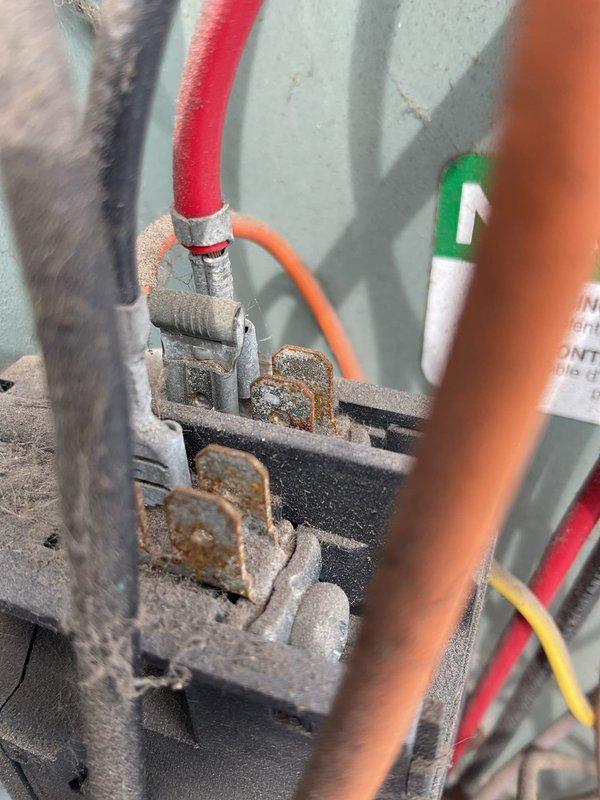 Completed comprehensive maintenance agreement service on dual-zone HVAC system consisting of two air conditioning units and two furnaces. The upstairs unit (8-10 years old) and downstairs unit (5 years old) were both inspected and serviced according to maintenance protocol. Performed electrical diagnostics using multimeter testing equipment, recording voltage readings of 62.1V at terminal connections. Inspected electrical terminal blocks and wire connections, noting significant dust accumulation on control components that was addressed during service. All system connections, including control wiring and refrigerant lines, were examined for proper operation and safety compliance.