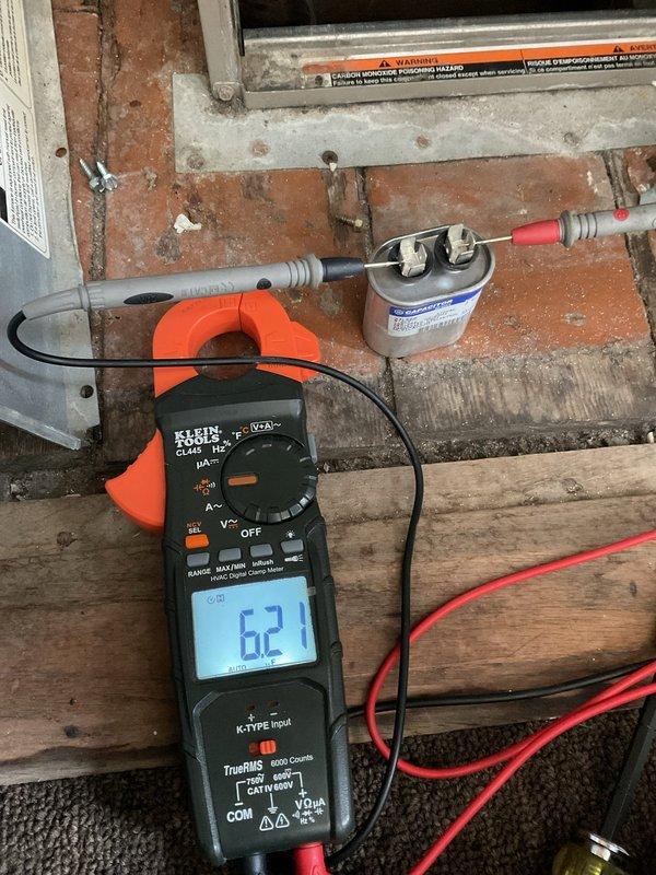 Completed comprehensive maintenance agreement service on dual-zone HVAC system consisting of two air conditioning units and two furnaces. The upstairs unit (8-10 years old) and downstairs unit (5 years old) were both inspected and serviced according to maintenance protocol. Performed electrical diagnostics using multimeter testing equipment, recording voltage readings of 62.1V at terminal connections. Inspected electrical terminal blocks and wire connections, noting significant dust accumulation on control components that was addressed during service. All system connections, including control wiring and refrigerant lines, were examined for proper operation and safety compliance.