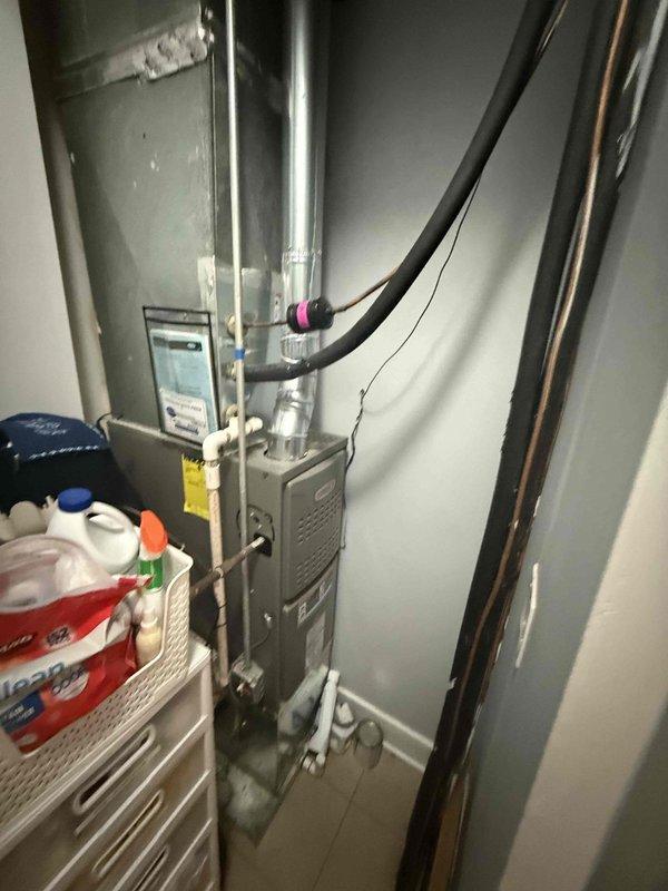 Responded to no cooling complaint on residential HVAC system less than 10 years old. Upon arrival, inspected furnace and air conditioning unit located in interior utility closet with connected refrigerant lines and ductwork. Verified system installation and checked saturation temperatures as directed for diagnostic assessment. Documented equipment condition and mechanical room configuration with photos showing gas line connections, refrigerant line routing through ceiling access, and overall system layout. Coordinated with technical support regarding temperature readings and diagnostic findings. Payment approved for diagnostic service and any necessary repairs via ACH processing per customer authorization.