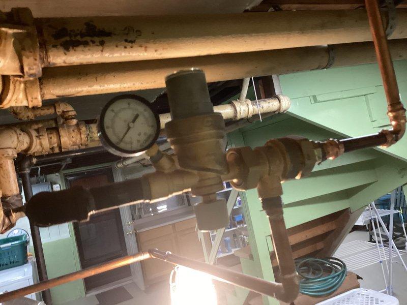 Completed preventive maintenance inspection on residential boiler system and expansion tank. Inspected all piping connections, pressure gauge readings, valves, and system components for proper operation. Documented existing conditions of aging infrastructure including piping, fittings, and pressure vessel with photographic records for maintenance history.