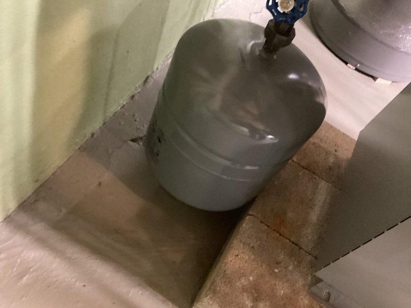 Completed preventive maintenance inspection on residential boiler system and expansion tank. Inspected all piping connections, pressure gauge readings, valves, and system components for proper operation. Documented existing conditions of aging infrastructure including piping, fittings, and pressure vessel with photographic records for maintenance history.