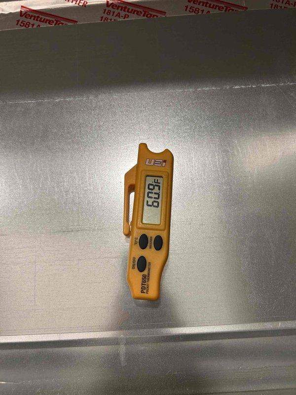 Returned to system after coil thaw period to complete diagnostic assessment on no cooling complaint. Measured and documented supply air temperatures at multiple points, recording readings of 59.8°F and 75°F to verify proper system operation and adequate temperature differential across evaporator coil following thaw completion.