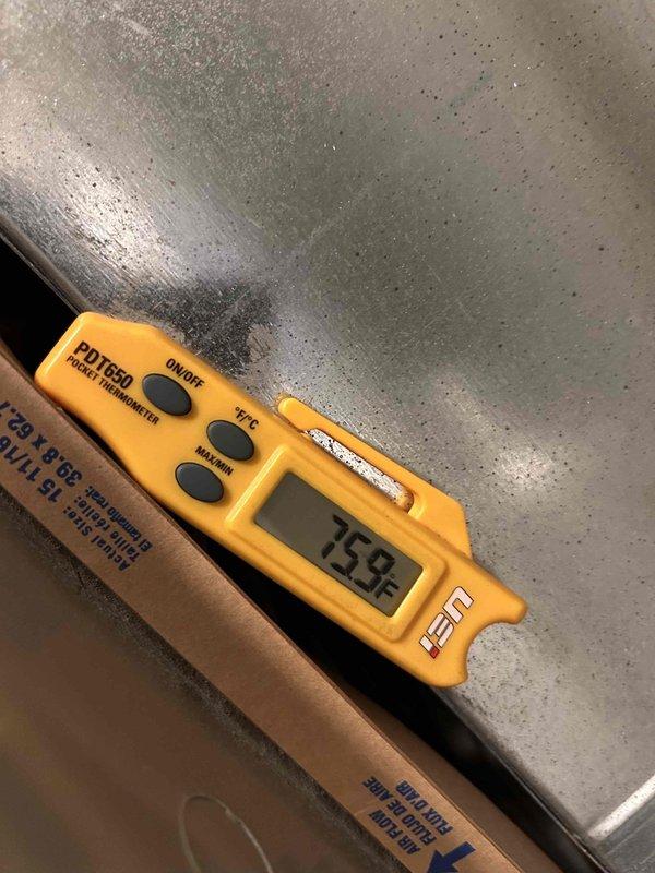 Returned to system after coil thaw period to complete diagnostic assessment on no cooling complaint. Measured and documented supply air temperatures at multiple points, recording readings of 59.8°F and 75°F to verify proper system operation and adequate temperature differential across evaporator coil following thaw completion.
