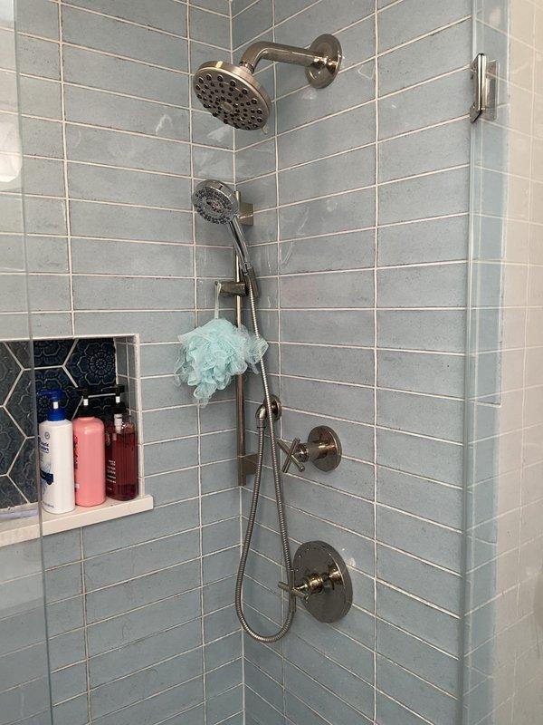 Responded to customer complaint of insufficient water pressure from shower system. Upon inspection, diagnosed and resolved low flow issue affecting dual shower setup with rainfall and handheld showerheads. Performed necessary adjustments to restore proper water pressure and verified both shower fixtures operating at optimal flow rate.
