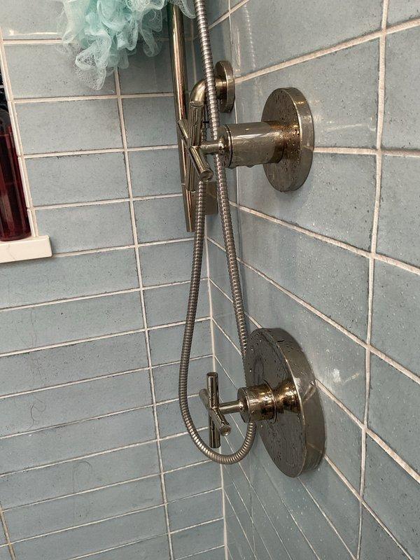 Responded to customer complaint of insufficient water pressure from shower system. Upon inspection, diagnosed and resolved low flow issue affecting dual shower setup with rainfall and handheld showerheads. Performed necessary adjustments to restore proper water pressure and verified both shower fixtures operating at optimal flow rate.