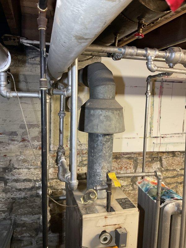 Responded to service call for reported gas leak in basement. Upon arrival, conducted thorough inspection of gas piping system and mechanical equipment area. Located minor gas leak at threaded pipe connection near water heater installation. Performed leak detection testing using approved methods to confirm location and severity of leak. Shut down gas supply to affected area and verified system isolation. Disassembled leaking joint, inspected threads for damage and proper engagement. Applied new pipe thread sealant and reassembled connection to manufacturer specifications. Restored gas supply and conducted comprehensive leak check of repair and surrounding connections using electronic gas detector and soap solution. Verified all connections were secure with no detectable leaks. Tested system operation and confirmed proper function of all equipment. Documented conditions with photographs showing basement mechanical room, exposed piping, and equipment layout for service records.