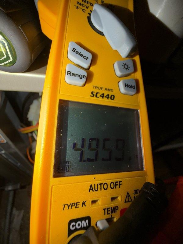 Returned to property to complete scheduled HVAC maintenance on upstairs furnace unit that required smaller technician for access. Upon inspection, discovered evaporator coils with significant frost and ice accumulation, indicating potential airflow restriction, refrigerant issue, or system operational problem. Documented temperature readings of 49.5 degrees using calibrated Fluke SC440 TRUE RMS multimeter and captured photographic evidence of iced coils for service records.