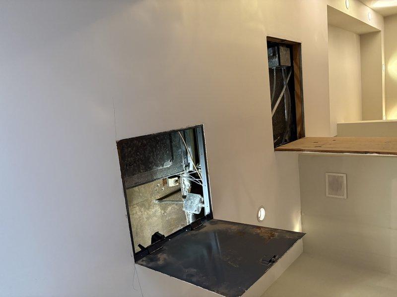 Provided estimate for replacement of two obsolete 1960s-era fan coil units utilizing 2-pipe hot and chilled water system. Units are ceiling-mounted and require access panel removal with Allen wrench for inspection. Assessment confirmed aging equipment with exposed ductwork, copper refrigerant lines, and electrical connections in mechanical space. Documented existing installation including metal framework, concrete block wall mounting, and current piping configuration to determine replacement specifications and access requirements.
