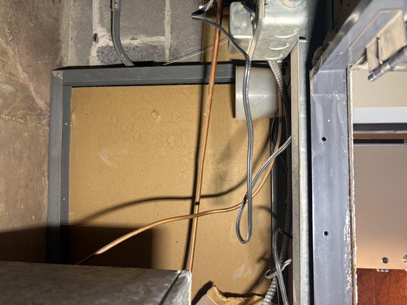 Provided estimate for replacement of two obsolete 1960s-era fan coil units utilizing 2-pipe hot and chilled water system. Units are ceiling-mounted and require access panel removal with Allen wrench for inspection. Assessment confirmed aging equipment with exposed ductwork, copper refrigerant lines, and electrical connections in mechanical space. Documented existing installation including metal framework, concrete block wall mounting, and current piping configuration to determine replacement specifications and access requirements.