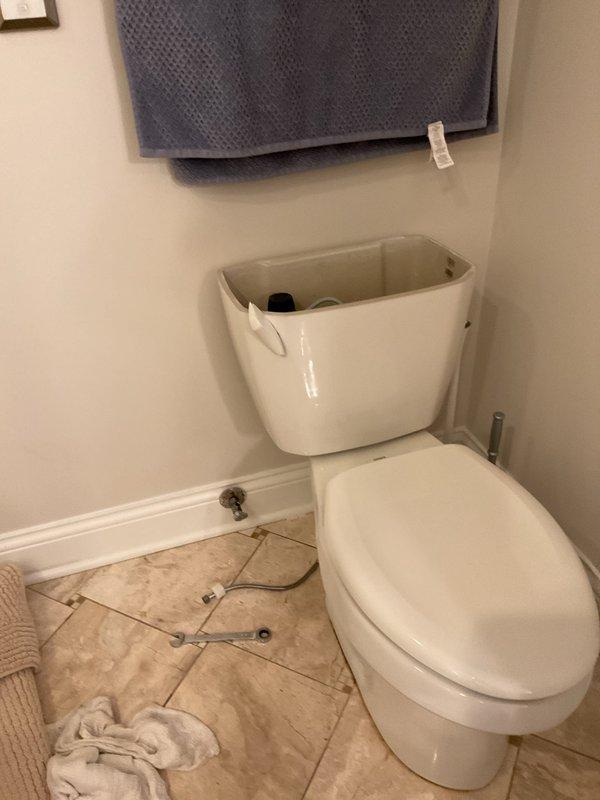 Responded to service call for running toilet issue. Upon arrival, assessed the existing toilet and determined replacement was necessary based on previous measurements taken. Removed old toilet fixture and installed new two-piece toilet unit. Positioned new wax ring seal and mounting hardware, securing toilet base to floor flange with brass closet bolts and rubber washers. Connected water supply line to fill valve and tested for proper operation and seal integrity. Verified no leaks at base or supply connection and confirmed proper flush mechanism function.