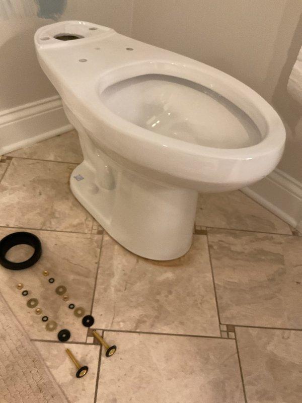 Responded to service call for running toilet issue. Upon arrival, assessed the existing toilet and determined replacement was necessary based on previous measurements taken. Removed old toilet fixture and installed new two-piece toilet unit. Positioned new wax ring seal and mounting hardware, securing toilet base to floor flange with brass closet bolts and rubber washers. Connected water supply line to fill valve and tested for proper operation and seal integrity. Verified no leaks at base or supply connection and confirmed proper flush mechanism function.