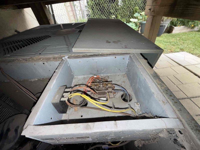 Responded to no-cool condition on 15-year-old air conditioning system where unit fan continued to operate but cooling ceased, causing first floor temperature rise. Upon arrival, opened outdoor condensing unit and performed comprehensive inspection of electrical components, including capacitor, contactor, and motor connections. Found intermittent electrical fault causing compressor lockout, which temporarily resolved with power cycle but indicated failing contactor with pitted contacts and weak coil. Replaced defective contactor, cleaned accumulated debris from internal compartment, verified all wire connections secure, and tested system operation through complete cooling cycle. Unit restored to proper cooling operation with compressor engaging reliably. Advised customer that system age and component wear may result in additional service needs in near future.