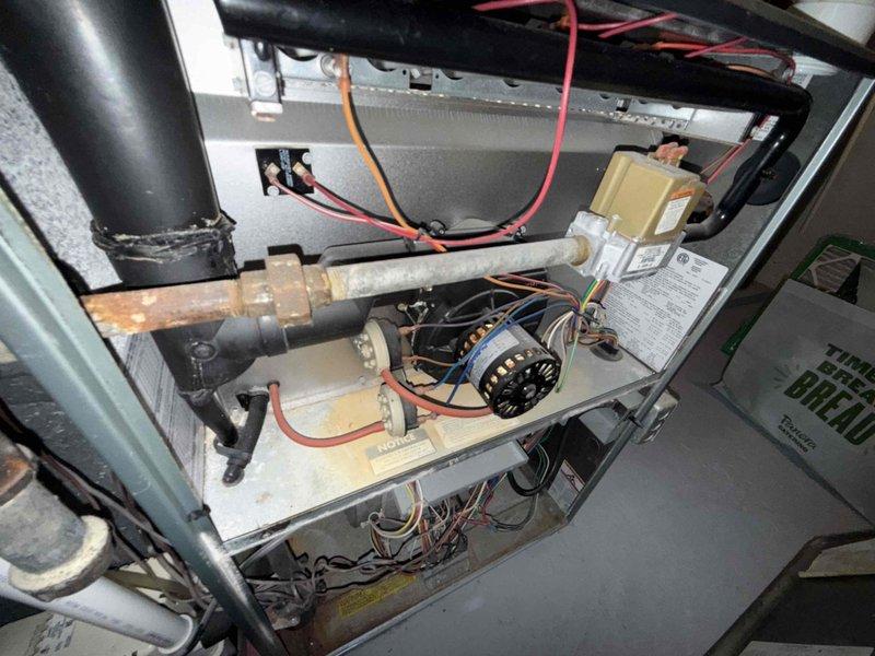 Responded to no-cool condition on 15-year-old air conditioning system where unit fan continued to operate but cooling ceased, causing first floor temperature rise. Upon arrival, opened outdoor condensing unit and performed comprehensive inspection of electrical components, including capacitor, contactor, and motor connections. Found intermittent electrical fault causing compressor lockout, which temporarily resolved with power cycle but indicated failing contactor with pitted contacts and weak coil. Replaced defective contactor, cleaned accumulated debris from internal compartment, verified all wire connections secure, and tested system operation through complete cooling cycle. Unit restored to proper cooling operation with compressor engaging reliably. Advised customer that system age and component wear may result in additional service needs in near future.