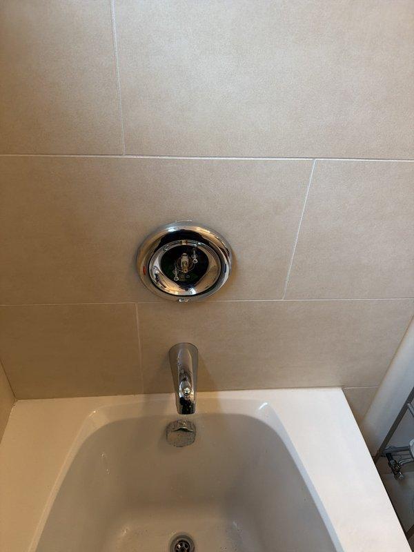 Responded to service call for shower intermittently shutting off when hot water was activated. Diagnosed issue as faulty pressure-balancing valve mechanism in tub/shower trim assembly. Accessed water heater and supply lines in mechanical cabinet to verify adequate hot water pressure and temperature. Disassembled chrome shower diverter and trim components from tiled bathroom wall. Replaced defective pressure-balancing cartridge and reassembled fixtures. Tested system operation through multiple hot water cycles to confirm proper function and temperature regulation without shutoff issues.