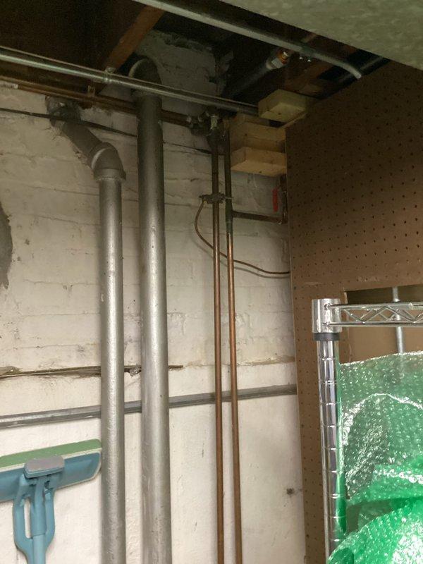 Responded to clogged laundry room sink in basement utility area. Upon inspection, located the affected drain line among the exposed plumbing infrastructure including PVC waste lines and copper supply piping. Successfully cleared the obstruction using professional drain cleaning equipment, restoring proper drainage and flow to the laundry sink. Verified system operation and confirmed no additional blockages in the drain system.
